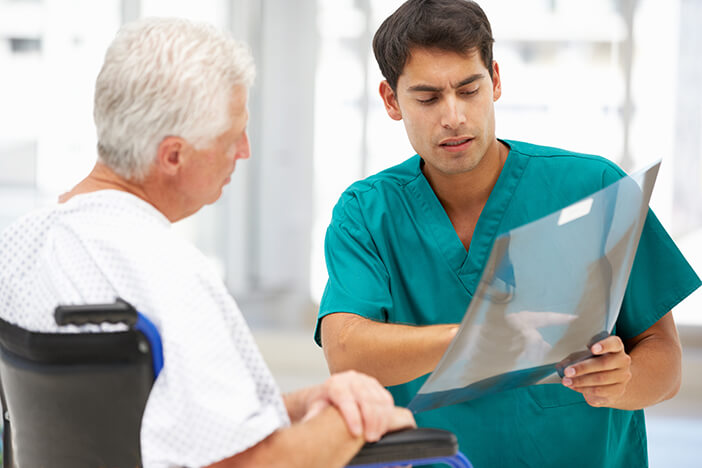 medical person discussing xray with patient